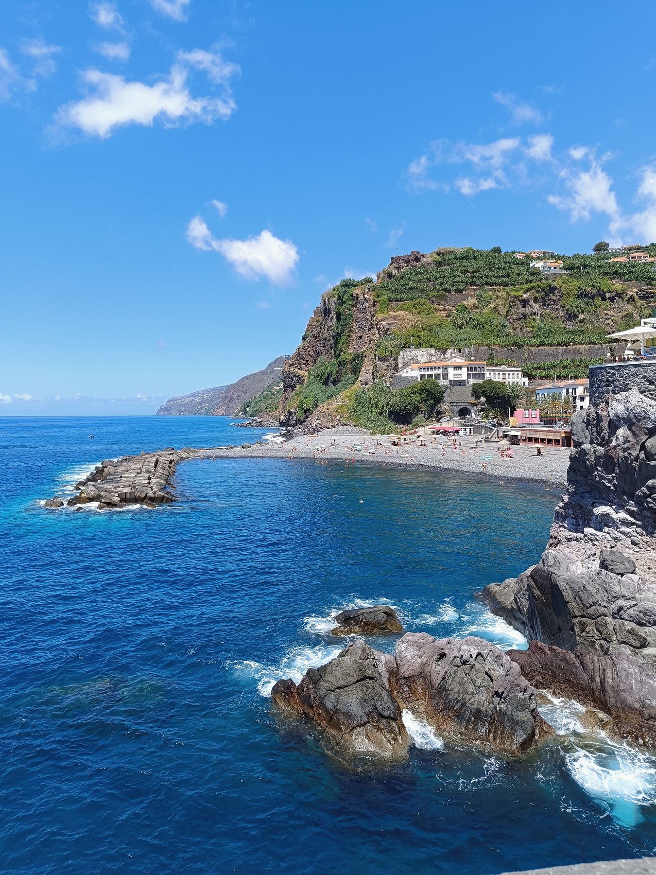 Ponta do Sol beach and blue Atlantic water below green coastal cliffs